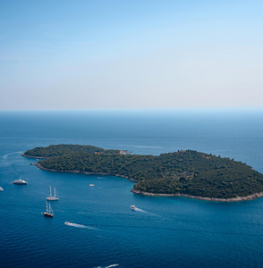 Stunning Aerial View of a Secluded Island Surrounded by Crystal-Clear Blue Waters
