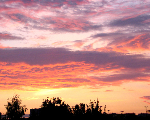 Colorful Sunset Sky Over A City by Fotimenow