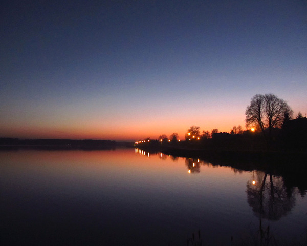 Sunset Sky By A Lake With Lights by Fotimenow