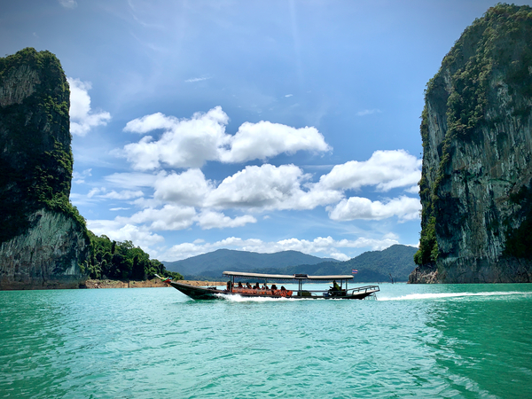 Boat Between Massive Rocks Print