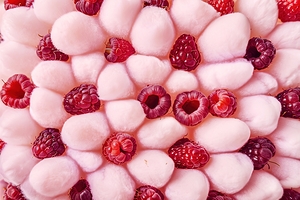 A vibrant arrangement of raspberries against a so