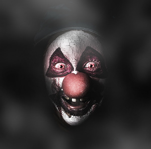 Dark evil clown face with scary joker smile