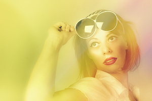 Beautiful retro pin-up girl wearing futuristic sunglasses 