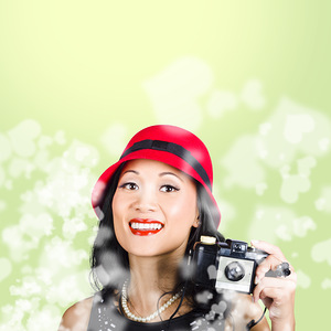 Woman taking photographs with vintage camera