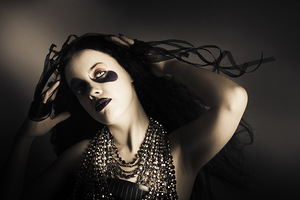 Young grunge fashion girl. Wavy dark hair style