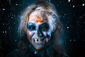 Evil winter monster smiling beneath falling snow