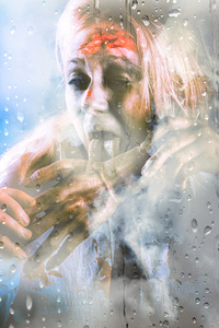 Scary horror zombie licking human hand at window