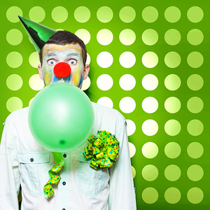 Crazy Party Clown Inflating Green Party Balloon