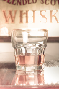 Vintage pub whisky on old wooden counter