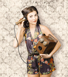 Cute housewife in 50s style on vintage phone