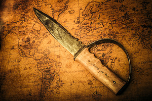 Pirate sword on buried treasure map