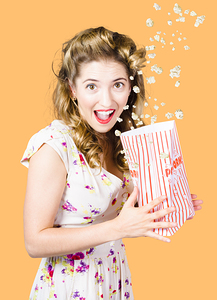 Shock horror pinup girl watching scary movie