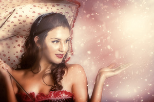 Beautiful woman catching rain in summer sun shower