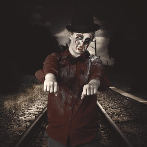 Zombie walking undead down train tracks