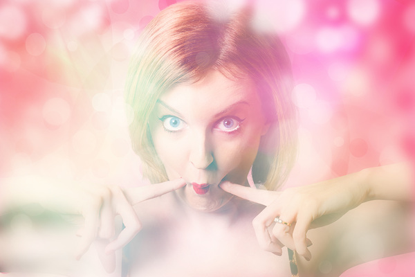 Blushing pinup girl in haze of makeup hues by Jorgo