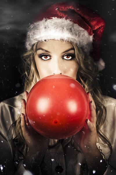 Young Christmas Girl Blowing Up Party Balloon by Jorgo