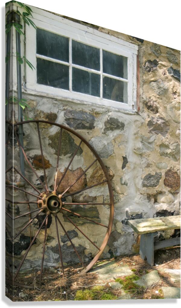 Rusty Wheel and Stone Wall Canvas Print