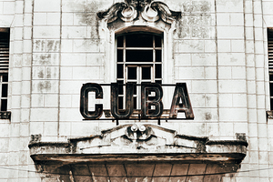 Aged inscription Cuba at entrance of building 