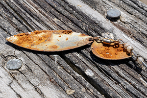 Rusty lure on wood rail