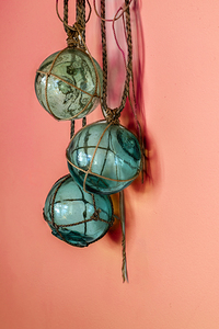 Glass fishing floats hanging on a wall