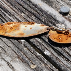 Rusty lure on wood rail