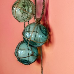 Glass fishing floats hanging on a wall