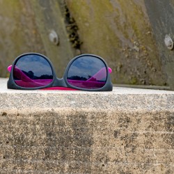 Abandoned sunglasses on concrete ledge