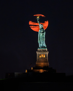 Sturgeon Moon Rising behind Lady Liberty