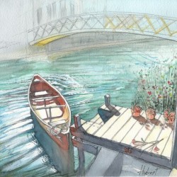 A small boat moored to a pontoon