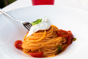 Italian pasta - spaghetti with burrata cheese closeup mediterra