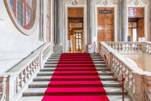 Turin - Italy. Red carpet in Royal Palace - luxury elegant marble stairway