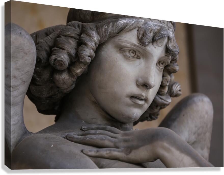 Guardian angel statue in antique cemetery. Canvas Print