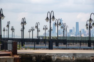 Rows of Street Lights in front of the NYC Skyline