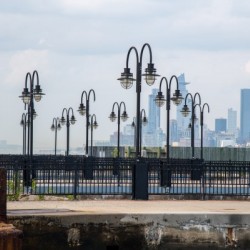 Rows of Street Lights in front of the NYC Skyline