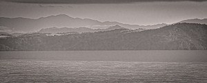 Mountain Silhouettes Over Still Water