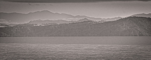 Mountain Silhouettes Over Still Water by Chirag Pandya