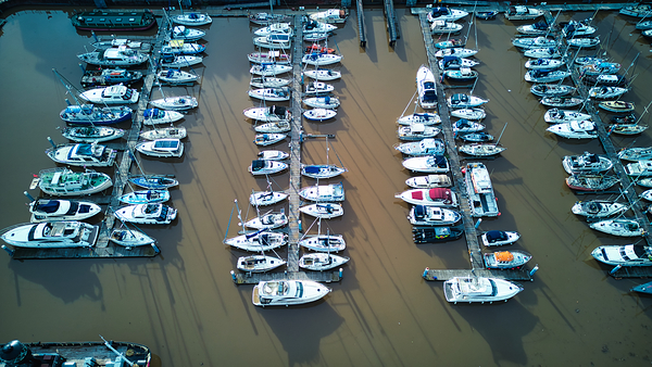 Aerial view of a marina with rows of moored boats reflecting the organized aspect of nautical life in Hull England. by Vasile Jechiu
