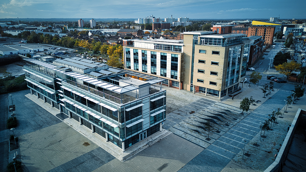 Aerial view of modern office buildings with parking lot in an urban landscape in Hull England. by Vasile Jechiu