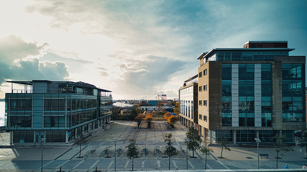 Modern office buildings with glass facades at sunset urban landscape in Hull England. by Vasile Jechiu