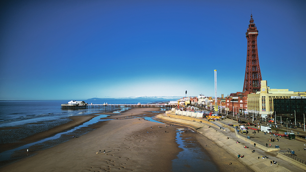 Scenic view of Blackpool beach and tower on a sunny day with clear blue skies and calm sea popular UK seaside destination. by Vasile Jechiu