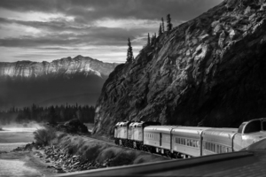 Train approaches the rocky mountains - Canada