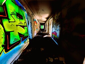 Glowing Grafiti On Decaying Hallway Of Abandoned Luxury Hotel
