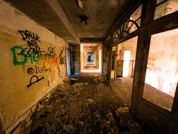 Decaying Hallway With Grafiti In Abandoned Luxurious Hotel by Mr Apple
