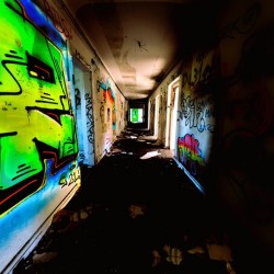 Glowing Grafiti On Decaying Hallway Of Abandoned Luxury Hotel