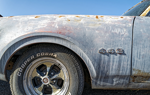 The front driver side quarter panel on an antique Oldsmobile 442