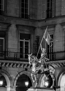 gold joan of arc statue near the louvre  vertical