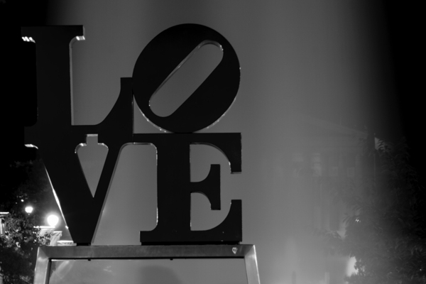 couples pose under love sculpture  horizontal 223 Print