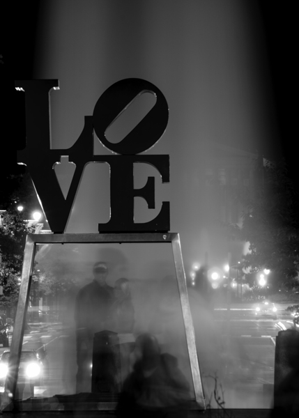couples pose under love sculpture  vertical 2237 Print