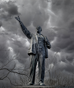 Statue of Lenin against a dark stormy sky Hungary
