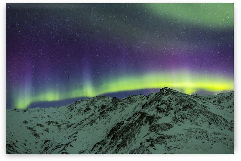 Aurora borealis over mountains within Denali National Park on a very cold winter night.  The Andromeda Galaxy is visible to the left; Alaska, United States of America by PacificStock
